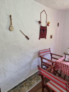 a dining room with a table and two chairs at Apartmani kod Kmeta in Janja