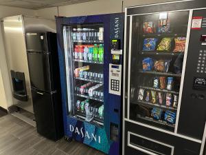 a drink vending machine in a store with drinks at Red Roof Plus Belleville in Belleville