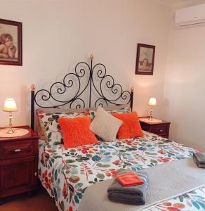 a bedroom with a bed with orange pillows at "Joseph 2" Stylish corner flat with open views, just 5km from the beach in Siġġiewi