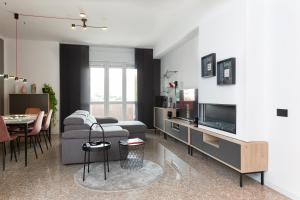 a living room with a couch and a tv at Exclusive Guest House - Fiera Milano Rho in Rho