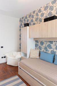 a bedroom with a bunk bed and a chair at Exclusive Guest House - Fiera Milano Rho in Rho