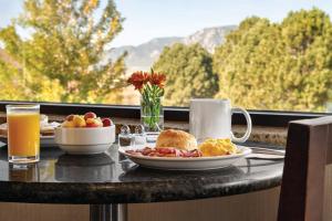 a breakfast table with a plate of breakfast food and a window at Radisson Hotel Colorado Springs Airport in Colorado Springs