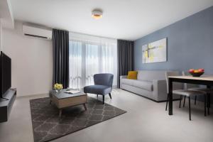 a living room with a couch and a table at LUX VISTA Suite in Umag