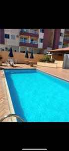 einem großen blauen Pool vor einem Gebäude in der Unterkunft Apartamento com Vista para o Mar in Conceição da Barra