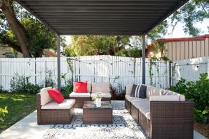 a patio with two couches and a table at Casa Alma in Tampa