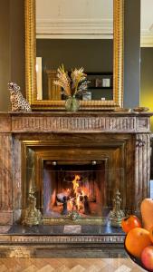 a fireplace in a living room with a mirror at La Course in Bordeaux