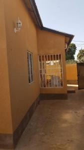 a building with a gate in front of it at Annex House For Rent in Manjai Kunda