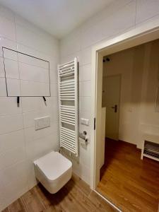 a bathroom with a toilet in a room at Dizajnový Apartmán - Tehelné Pole - free parking in Bratislava