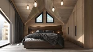 - une chambre avec un lit dans une pièce dotée d'une fenêtre dans l'établissement Grand Chalet Donovaly, à Donovaly