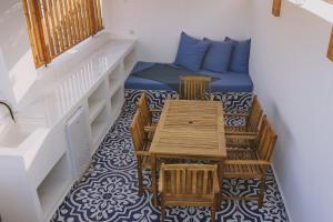 a room with a table and chairs and a couch at Minoos Residence with roof pool in Rethymno