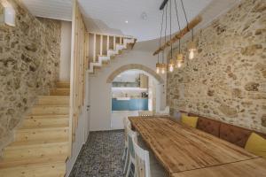 a dining room with a wooden table and stairs at Minoos Residence with roof pool in Rethymno +23 photos
