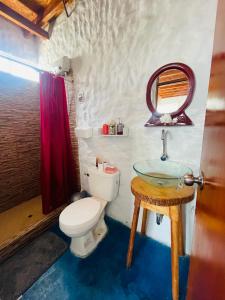 a bathroom with a toilet and a sink at Huanchaco Domes in Huanchaco