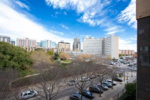 a city skyline with cars parked in a parking lot at SingularStays Palacio de Congresos in Valencia