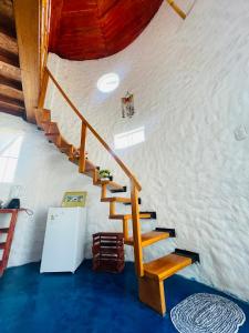 a staircase in a house with a wooden ceiling at Huanchaco Domes in Huanchaco