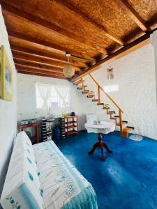 a living room with a blue floor and a staircase at Huanchaco Domes in Huanchaco +29 photos