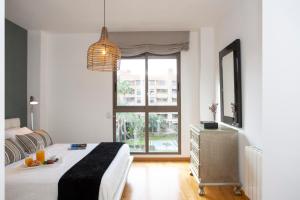 a bedroom with a bed and a large window at SingularStays Palacio de Congresos in Valencia +32 photos