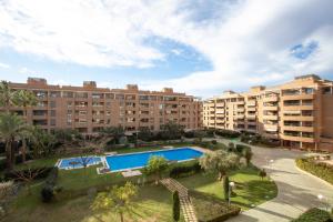 an apartment complex with a swimming pool and buildings at SingularStays Palacio de Congresos in Valencia