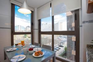 a dining room with a table with food on it at SingularStays Palacio de Congresos in Valencia
