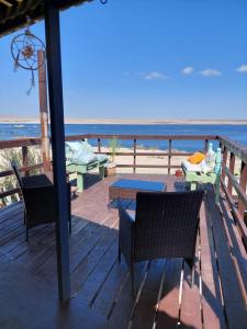 una terraza con sillas y mesas en la playa en Aldea Bahiguana Piso Privado 5 personas, en Bahía Inglesa