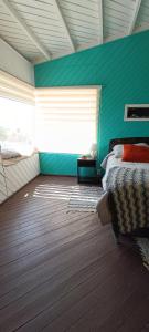 una camera con letto e parete verde di Aldea Bahiguana Piso Privado 5 personas a Bahia Inglesa