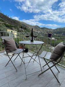 a bottle of wine sitting on a table on a patio at La casa di Rosetta in Levanto