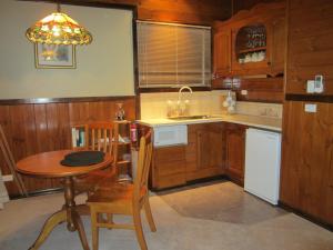 a kitchen with a table and a small table and chairs at Willowlake Cottages in Howqua