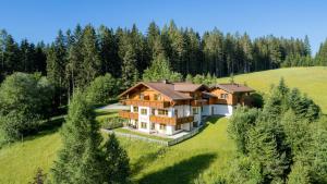 an aerial view of a large house on a hill at Landhaus Bellevue in Ramsau am Dachstein