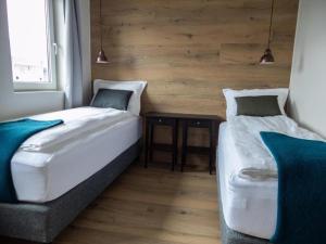 two beds in a small room with a table at Stracta Apartments in Kirkjubæjarklaustur +37 photos