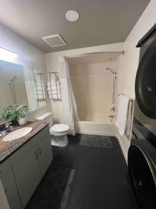 a bathroom with a sink and a toilet and a shower at San Diego Gaslamp Loft Getaway in San Diego