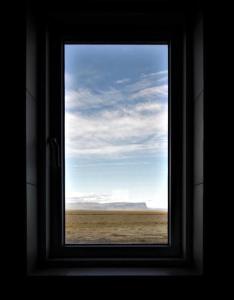 a window with a view of the desert through it at Stracta Apartments in Kirkjubæjarklaustur