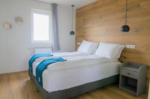 a bedroom with a large bed with a wooden headboard at Stracta Apartments in Kirkjubæjarklaustur