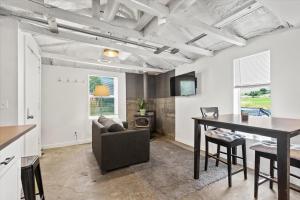 a kitchen and living room with a table and a couch at The River Box - Luxury Container Home - views and Hot Tub in Yakima