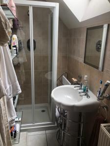 a bathroom with a sink and a shower at Executive Serviced apartments 2 in Forfar