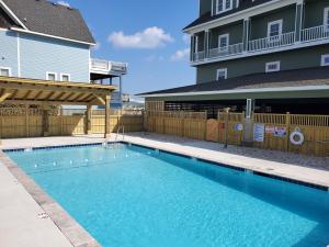 a swimming pool in front of a building at FFR101 - The Wright Idea in Kill Devil Hills