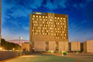 a large building with a parking lot in front of it at City Express Plus by Marriott Ciudad de México Mundo E in Mexico City