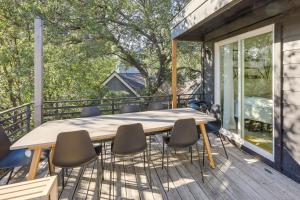 a deck with a wooden table and chairs at Stylish Austin Home with Hot Tub 3 Mi to Downtown! in Austin