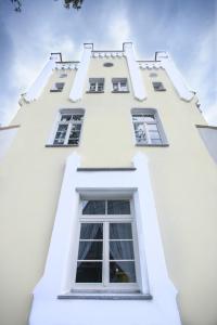 a white building with windows on the side of it at Villa Elizabeth in Bolków
