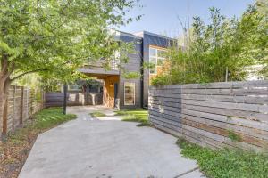 a house with a wooden fence next to a sidewalk at Stylish Austin Home with Hot Tub 3 Mi to Downtown! in Austin
