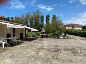 a patio of a house with a table and chairs at Podere Venanzio in Lido di Camaiore