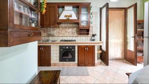 een keuken met houten kasten en een fornuis met oven bij VILLA ARCADIA in Oria