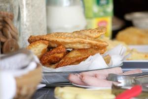 a plate of food with fried food on a table at Pousada Semente in Arraial d'Ajuda +52 photos