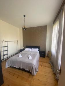 a bedroom with a bed with two towels on it at Zemarani Winery in Kʼveda Sakʼara