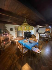 a dining room with a blue table and chairs at Zemarani Winery in Kʼveda Sakʼara
