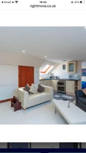 a living room with a white couch and a table at Executive Serviced apartments 2 in Forfar