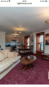 a living room with a couch and a coffee table at Executive Serviced apartments 2 in Forfar
