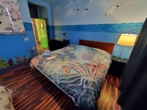 a bedroom with a bed with a painting on the wall at The Pirate Haus Inn in Saint Augustine