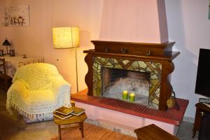 a living room with a fireplace with candles on it at Lila's Guest House in Mikrós Prínos