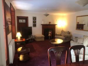 a living room with a couch and a tv at Executive Serviced apartments 2 in Forfar