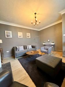 a living room with a couch and a table at The Woodlands - Zillo in Bishop Auckland