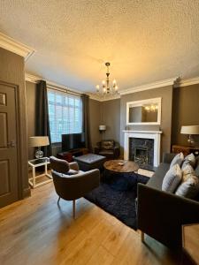 a living room with a couch and a fireplace at The Woodlands - Zillo in Bishop Auckland